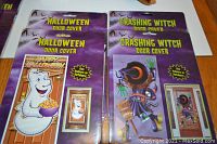 Four Halloween plastic door covers in original packaging depicting a white ghost and a crashing witch.