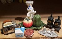 Front view of five sets of vintage salt and pepper shakers including toaster, milk carton, tomato, green pepper, stove, train, and tea set.