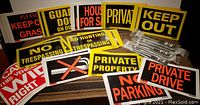Overview of approx. 100+ assorted plastic signs including yellow and black warning signs and red and white vehicle and private drive signs.