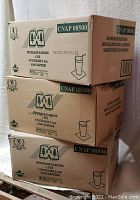 Three stacked unopened boxes labeled CNAP 08500 containing beverage napkins, 8 packages per box, 500 napkins each.