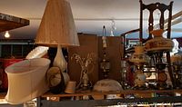 Photo showing multiple lamps including 2 hurricane style parlour lamps and assorted shades and lamp bases.