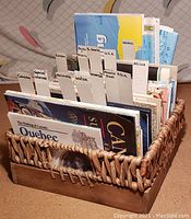 Basket filled with organized National Geographic foldouts and maps with cardboard dividers labeled by regions and topics.