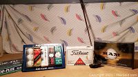 Full lot view showing the golf balls in original packaging and the RAM putter positioned upright.