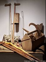 Antique seeder, walking sticks, concrete lion garden ornament, metal garden tool, toolbox with hand tools