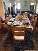 Full room view showing rectangular wooden dining table surrounded by chairs.