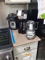 Overview of three kitchen appliances on countertop: Instant Pot, Cuisinart coffee maker, and Cuisinart Mini-Prep Plus chopper.
