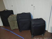 Four Samsonite luggage cases arranged in a row to show size and style differences including black and olive colors, all on wheels.