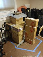 Wide view of stacked unopened Yamaha drum shell box with PDP hardware box and chrome stand leaning