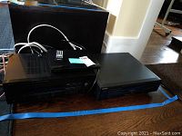 Sony DVD player and Yamaha AV receiver side by side on wooden surface with cables.