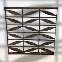 Full front view of the metal architectural salvage panel showing the repeated leaf patterned design and rusty metal surface.