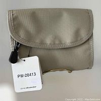Front view of the foldable tan nylon wallet with original Derek Alexander tag showing model number PW-20413.