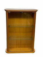 Front view of the wooden display cabinet showing two glass doors and two glass shelves inside