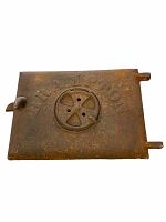 Front view of vintage cast iron stove door with visible patina and rust, embossed 'BRAMPTON' and circular adjustable vent.