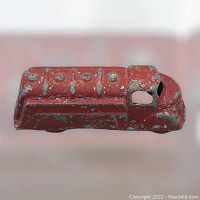 Top view of the vintage red cast metal London Toy Oil Tanker No. 13 showing heavy paint wear and detailed tank molds.