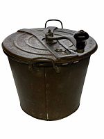 Full view of vintage No. 4 Universal Bread Maker showing circular metal container with embossed lid, crank handle, and latch clasps.