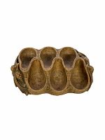 Front view of vintage carved pipe holder showing six pipe compartments and decorative leaf and acorn design on sides.