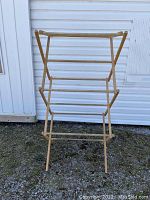 Front view of the vintage wooden clothes rack fully expanded showing multiple rungs for hanging clothes.