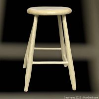 Front view of the vintage painted wooden stool showing the round seat and four legs with stretchers.