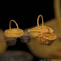 Five wicker baskets assortment: three natural light-colored and two smaller dark-colored baskets.