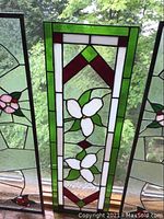Front view showing the full stained glass panel between two similar panels in situ
