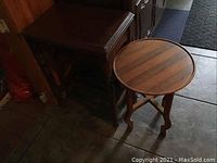 Photo showing both tables together, the rectangular dark wood table and the round light wood table side by side.