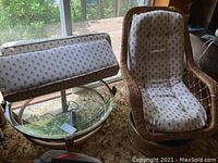 Overview of one chair alongside round glass-top table