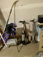 Overall view of two push carts, golf bag with clubs and tote of balls