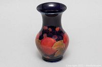 Front angle showing full shape and painted fruit design