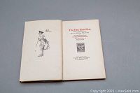 Photo showing two open pages of the book, including frontispiece and title page with book and author details.