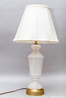 Front view of the vintage Murano glass table lamp with white fabric shade and brass base.