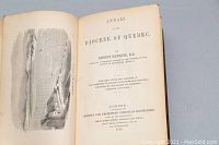 Open book showing title page and frontispiece illustration with visible text and author info.