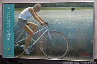 Full view of framed print showing person on bicycle and bird in field with text strip and framing.