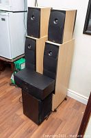 Full set stacked showing towers, satellites, center and subwoofer.