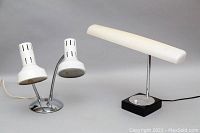 Two desk lamps on a grey background: a HITACHI Moon Light 506 lamp and a double light lamp with two white adjustable shades