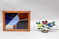 Framed stained glass wall hanging/window and floral stained glass lamp side by side