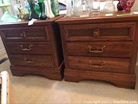 Photo showing two matching Kroehler wooden end tables side by side with decorative glassware on top.