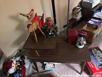 Mid-Century Modern multi-level wooden table with holiday decorations displayed temporarily on top, showing two rectangular tiers with distinct wood grain finish.