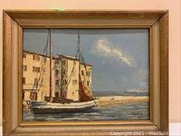 Full view of oil painting on canvas showing Mediterranean harbor with sailboats and buildings, framed.