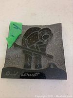 Soapstone carving showing a full view of the person holding a spear and carving details.