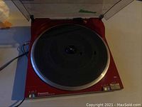 Front view of red Panasonic SL-N5 DC Servo Automatic turntable with platter and control buttons visible.