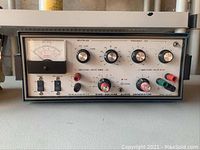 Front view of the HeathKit Sine Squeaker Audio Generator with meter, knobs, switches, and output terminals visible.