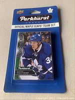 Sealed blister pack of 2016-17 Parkhurst hockey cards featuring Auston Matthews rookie card from Toronto Maple Leafs official team set.