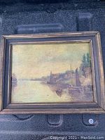 Framed oil painting on board, signed by C.H. Morgan, showing harbor and boats in muted tones