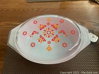 Top view of the Pyrex dish showing the decorative floral and bird pattern on the lid.