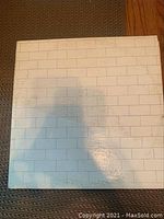 Front cover of Pink Floyd's The Wall vinyl album showing white brick wall design.