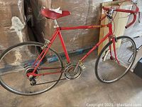 Full side view showing entire red AMF Scorcher adult bike, 26 inch rims, drop handlebars and frame geometry.