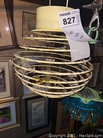 Photo of spiral solar-powered outdoor light showing coiled structure and cream top with solar panel.