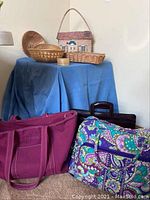 Overview of baskets on blue cloth, bags on floor nearby, showing variety and condition