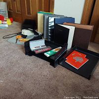 Desk organizer with pens, pencils, binders, paper cutter, and file trays.