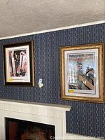 Both framed prints hung side by side above fireplace